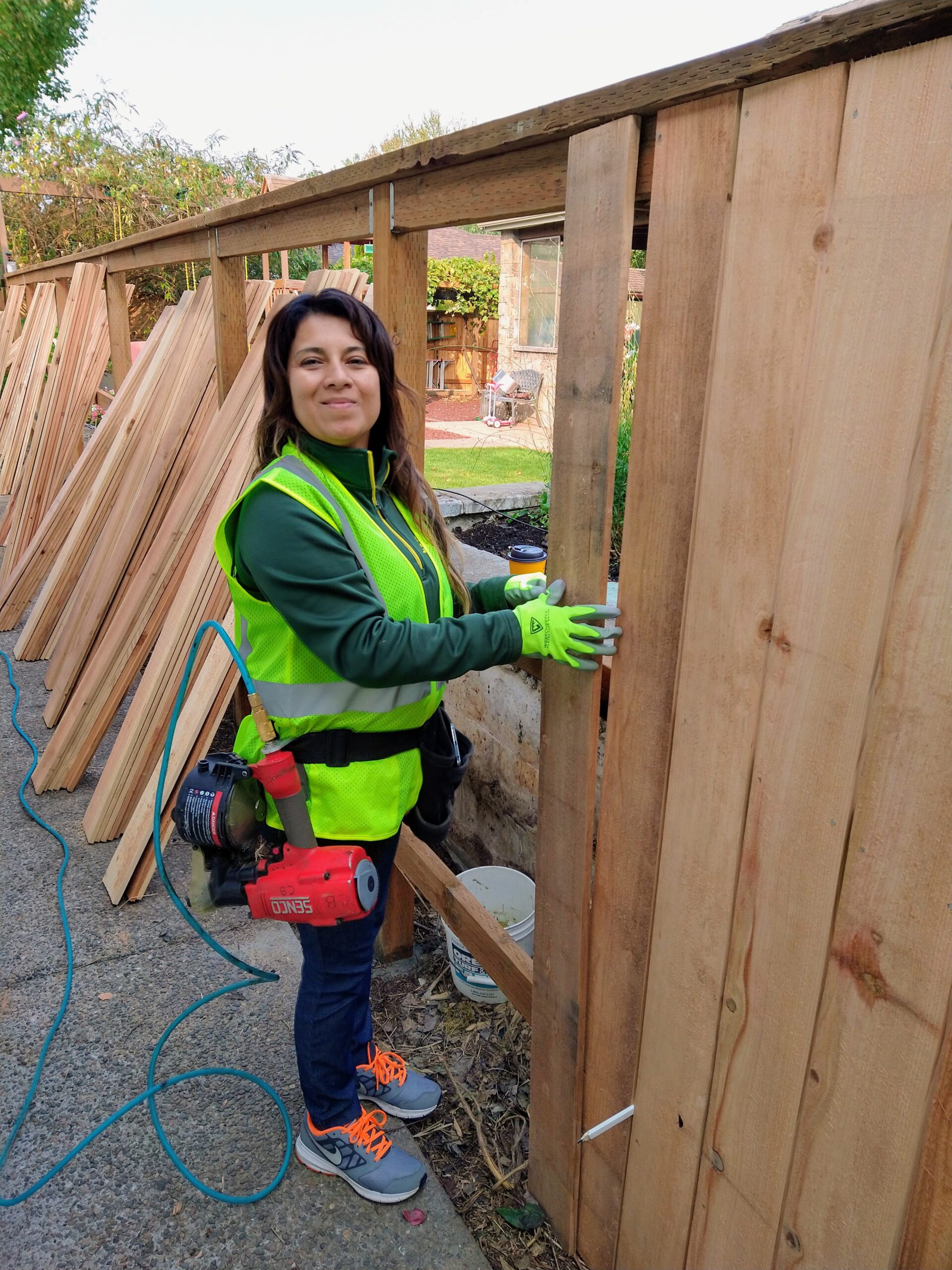Female employee building a fence